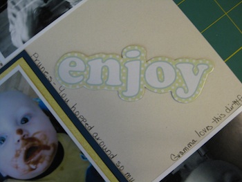 Chipboard word Enjoy placed on layout